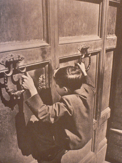 boy holding onto doorhandles